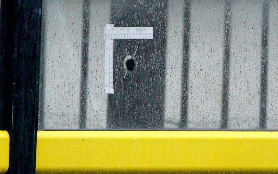 Forensic tape around a bullet hole at the Liverpool bus shelter - Peter Byrne/PA Wire