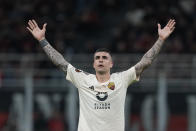 Roma's Gianluca Mancini celebrates after he scored his side's first goal during the Europa League quarterfinal first leg soccer match between AC Milan and Roma at the San Siro Stadium, in Milan, Italy, Thursday, April 11, 2024. (AP Photo/Antonio Calanni)