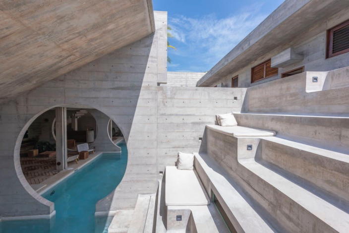 Tiered concrete lounges sit alongside Casa TO's infinity pool.