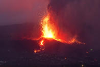 Lava from a volcano eruption flows on the island of La Palma in the Canaries, Spain, Tuesday, Sept. 21, 2021. A dormant volcano on a small Spanish island in the Atlantic Ocean erupted on Sunday, forcing the evacuation of thousands of people. Huge plumes of black-and-white smoke shot out from a volcanic ridge where scientists had been monitoring the accumulation of molten lava below the surface. (AP Photo/Emilio Morenatti)