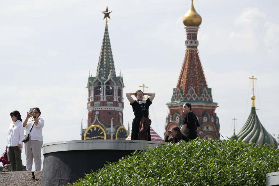 People walk in a park near the Kremlin in Moscow, Russia, Monday, June 26, 2023, on a day declared a holiday due to the situation in the country. (AP Photo/Dmitri Lovetsky)