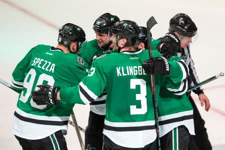 Apr 14, 2016; Dallas, TX, USA; Dallas Stars right wing Patrick Eaves (18) and defenseman John Klingberg (3) and center Jason Spezza (90) and left wing Jamie Benn (14) celebrate Eaves goal against Minnesota Wild goalie Devan Dubnyk (not pictured) during the third period in game one of the first round of the 2016 Stanley Cup Playoffs at American Airlines Center. The Stars shut out the Wild 4-0. Jerome Miron-USA TODAY Sports