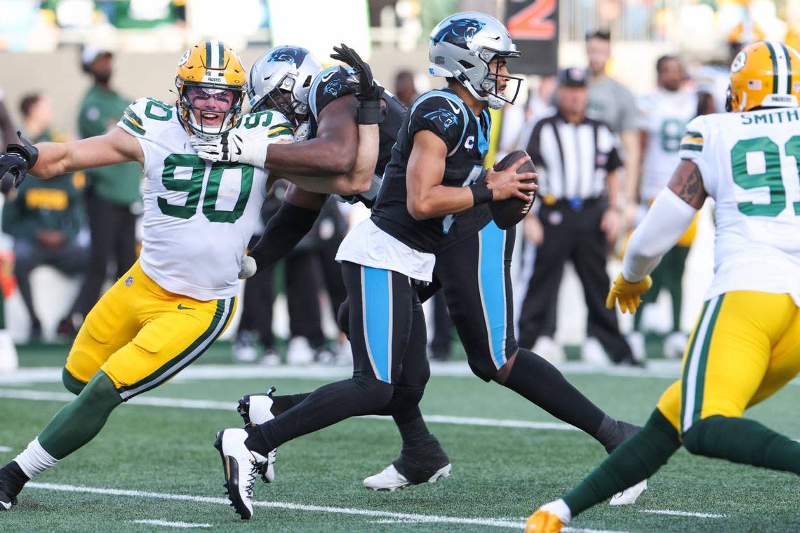 Green Bay Packers linebacker Lukas Van Ness (90) is held off by Carolina Panthers offensive tackle Ikem Ekwonu (79) during the game at Bank of America Stadium on Sunday, December 24, 2023.