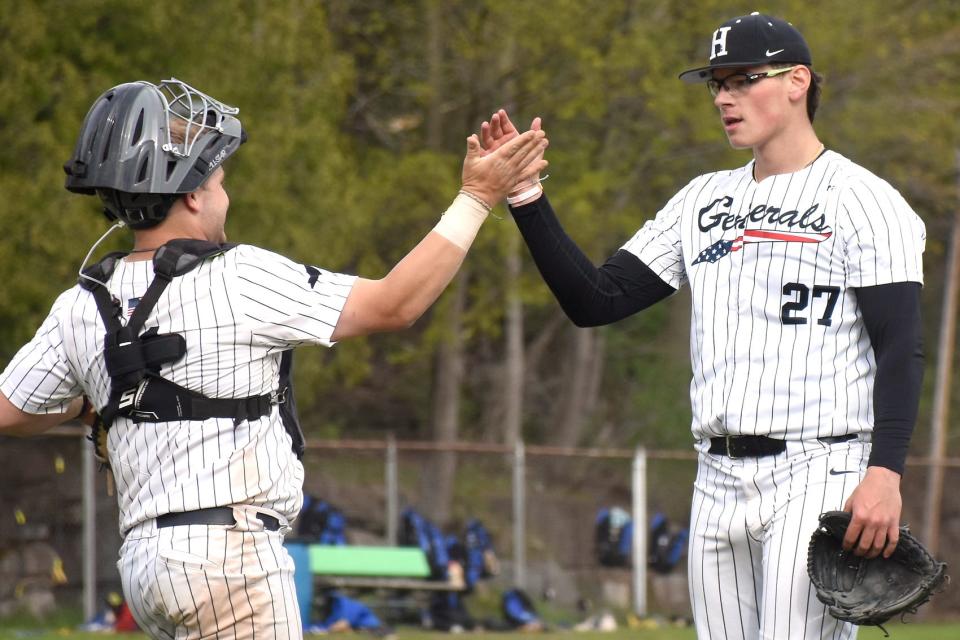 Herkimer College Generals Ty Gallagher and Greg Farone (from left) slap hands at the Veterans Memorial Park mound following a May 7 victory over Rowan College of South Jersey-Gloucester. Herkimer will join Gloucester and six other teams in Tennessee after receiving the lone wild card bid for the NJCAA's Division III tournament.