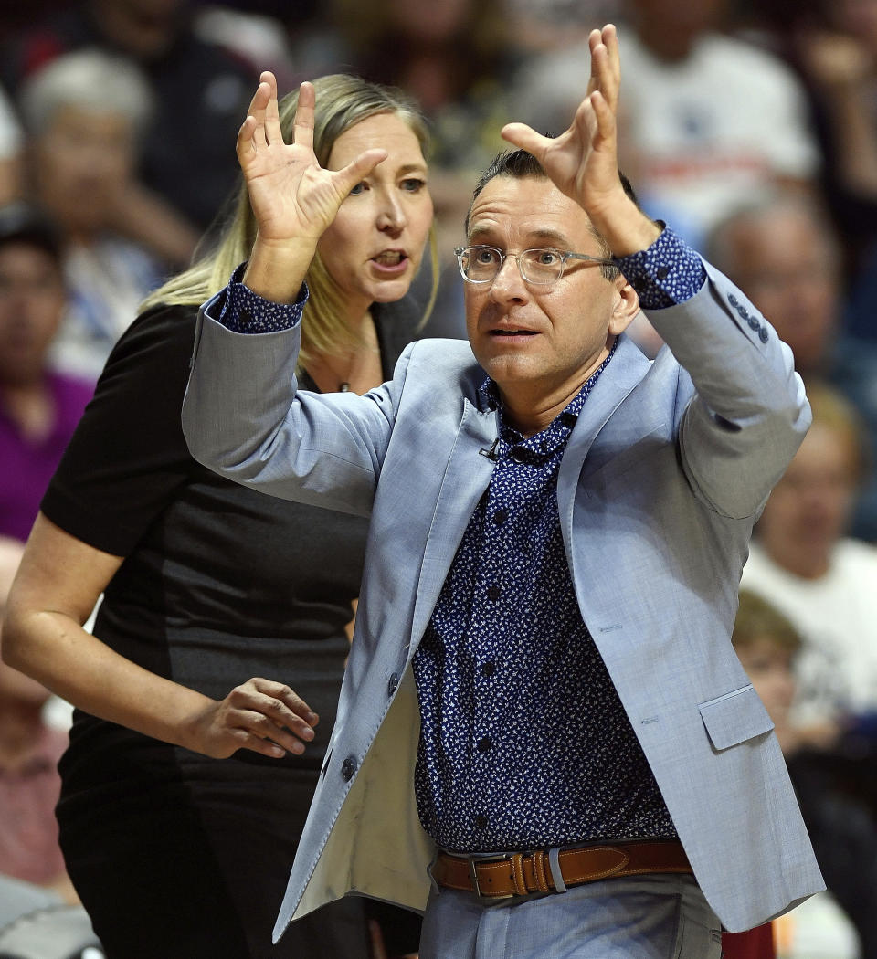 FILE - In this June 16, 2019, file photo, Connecticut Sun head coach Curt Miller, with assistant coach Brandi Poole behind, argues a call with the officials during play against the Seattle Storm in a WNBA basketball game, in Uncasville, Conn. No team has gotten off to a hotter start then the Connecticut Sun. (Sean D. Elliot/The Day via AP)