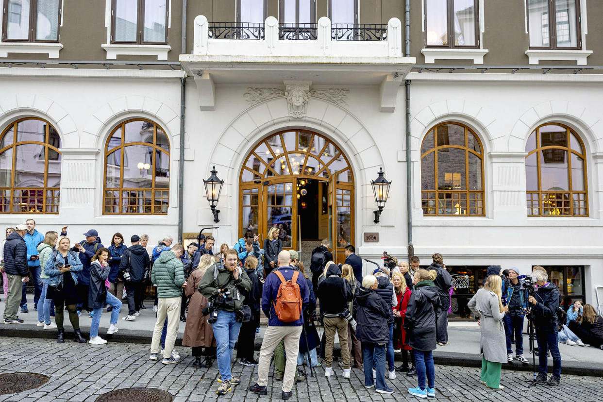 Media gather in front of Hotel 1904 in Alesund. (Albert Nieboer / DPA via AP)