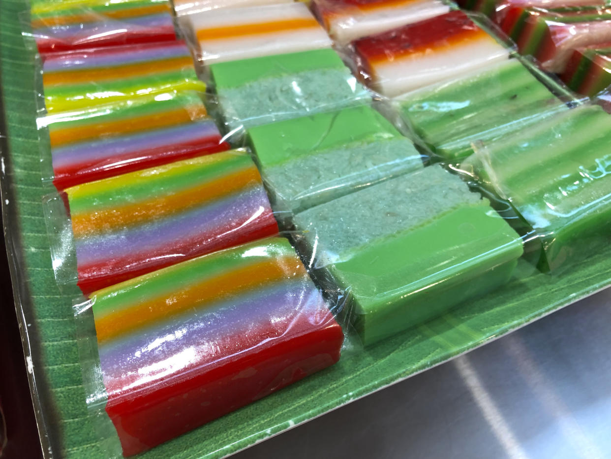Close-up of a plate of assorted nonya kueh served on a plate.