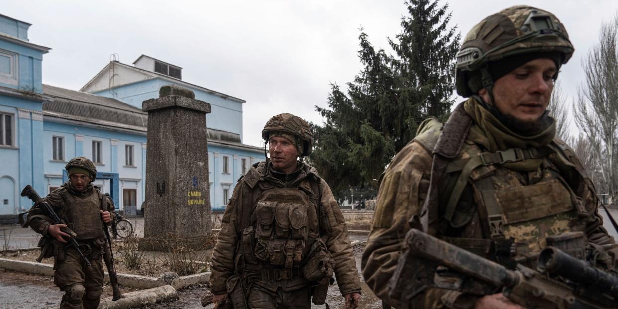 Ukrainian servicemen who recently returned from the trenches of Bakhmut walk on a street in Chasiv Yar, Ukraine, Wednesday, March 8, 2023.