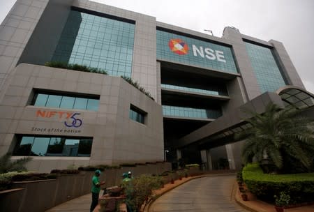 Gardeners work outside the National Stock Exchange building in Mumbai