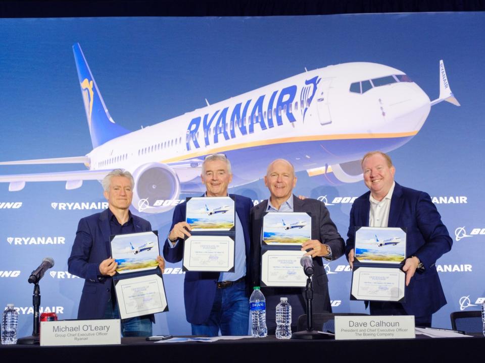 Four execs hold up certificates of sale for the Boeing 737 MAX 10s.