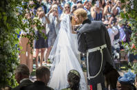 <p>The Duke and Duchess of Sussex kiss on their wedding day outside St George’s Chapel (Getty) </p>
