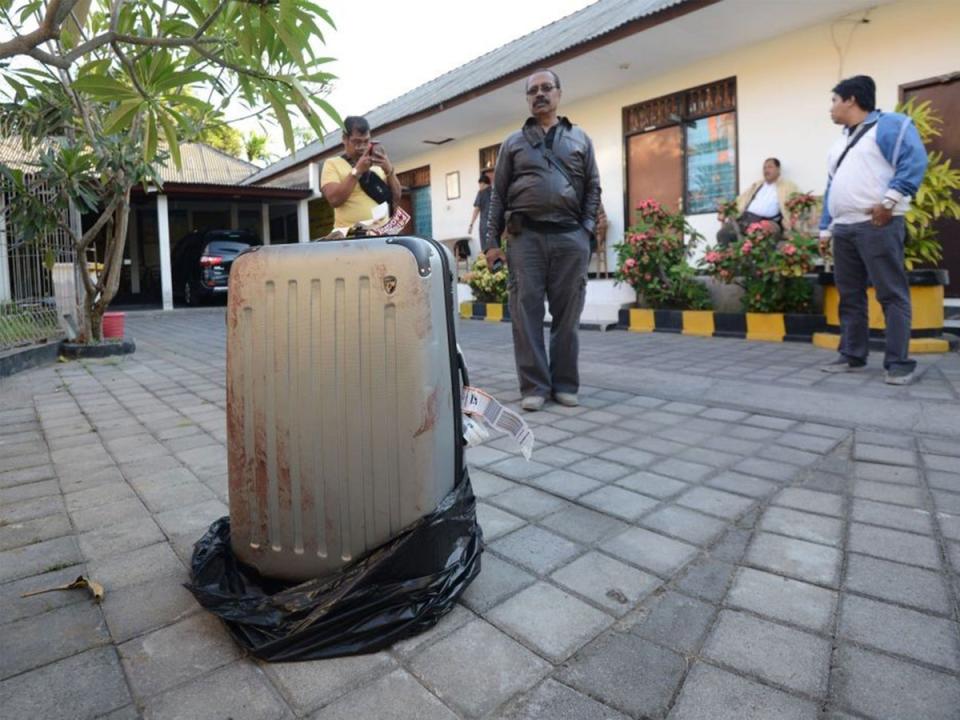 The bloody suitcase outside the St. Regis containing victim’s body (AP)