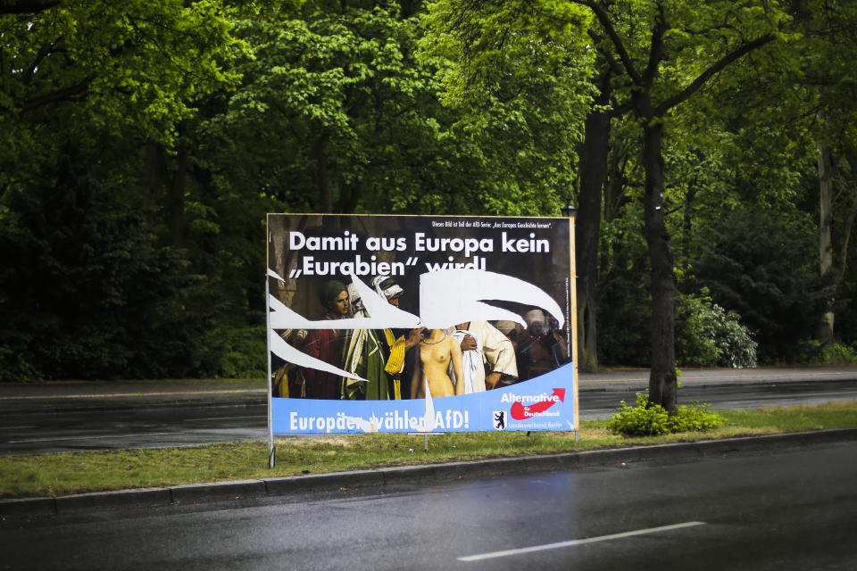 In this Monday, April 29, 2019 photo, an destroyed election campaign poster of the German Alternative fuer Deutschland (Alternative for Germany), AfD, party displayed at a road in Berlin, Germany. The poster for the European Parliament elections shows the painting 'Slave Market' from 1866 by the french artist Jean-Leon Gerome. The US museum 'The Clark Art Insitiute' in Williamstown, MA, owner of the painting, has asked the German far right party AfD not to use the picture any more. Top slogan reads 'So that Germany does not become an 'Eurabia'!. (AP Photo/Markus Schreiber)