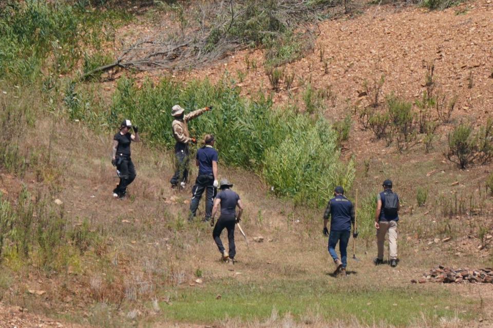 Personnel at Barragem do Arade reservoir, in the Algave, Portugal, as searches continue as part of the investigation into the disappearance of Madeleine McCann. The area is around 50km from Praia da Luz where Madeleine went missing in 2007. Picture date: Thursday May 25, 2023.