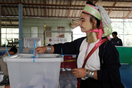 An ethnic Kayan woman, also known as a long neck villager casts her vote for the general election in Mae Hong Son, Thailand, March 24, 2019. REUTERS/Ann Wang
