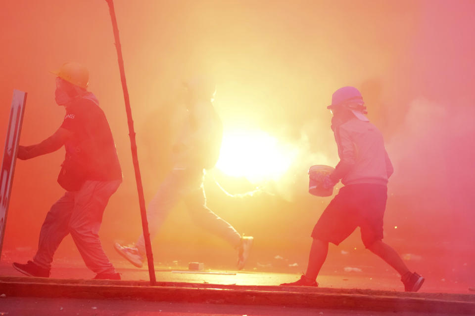 A so-called "deactivator" and "front-line" activist, face off with police during an anti-government protest in Lima, Peru, Saturday, Jan. 28, 2023. Protesters are seeking immediate elections, President Dina Boluarte's resignation, the release of ousted President Pedro Castillo and justice for protesters killed in clashes with police. (AP Photo/Martin Mejia)