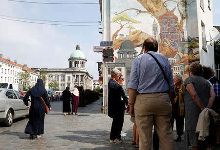 Tourists visit the market during a guided tour in the Brussels district of Molenbeek showing off the area's manufacturing heritage and diverse population, Belgium, August 14, 2016. REUTERS/Francois Lenoir