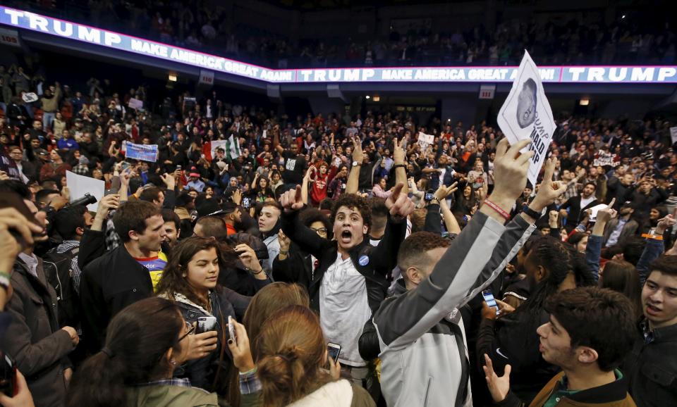 Demonstrators celebrate after Republican U.S. presidential candidate Donald Trump cancelled his rally at the University of Illinois in Chicago March 11, 2016. (REUTERS/Kamil Krzaczynski)