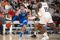 Boise State guard Max Rice (12) drives to the basket as Texas A&M's Wade Taylor IV and Henry Coleman III (15) defend during the second half of an NCAA college basketball game in Fort Worth, Texas, Saturday, Dec. 3, 2022. (AP Photo/Emil Lippe)