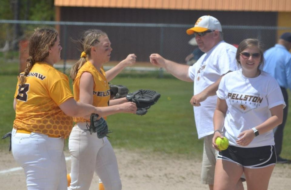 Pellston players get congratulated by then-assistant softball coach Randy Bricker (back right) during the 2021 season. Bricker, along with his daughter Kaitlyn (front right), helped out as coaches for the Hornets during that campaign. Bricker is now the head coach of the Hornets.