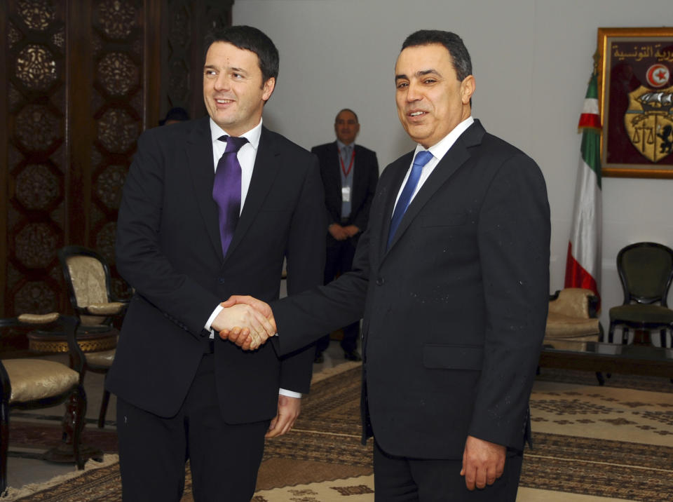 Tunisian Prime Minister, Mehdi Jomaa, right, greets his Italian counterpart, Matteo Renzi, upon his arrival at Tunis airport, Tunisia, Tuesday, March 4, 2014. Renzi is in Tunisia for a one-day official visit. (AP Photo/Hassene Dridi)