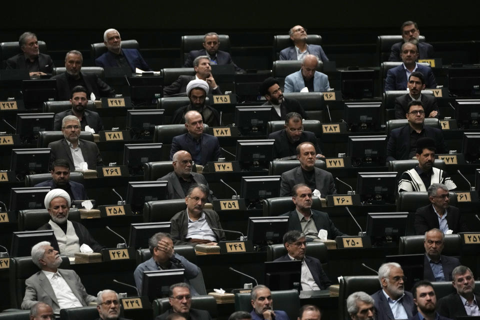 Iranian lawmakers attend the opening ceremony of a new parliament term, in Tehran, Iran, Monday, May 27, 2024. Monday marked the first day for Iran's newly elected parliament, following a March election that saw the country's lowest turnout since its 1979 Islamic Revolution. Of those elected to the 290-seat body, hard-liners hold over 230 seats, according to an Associated Press survey. (AP Photo/Vahid Salemi)