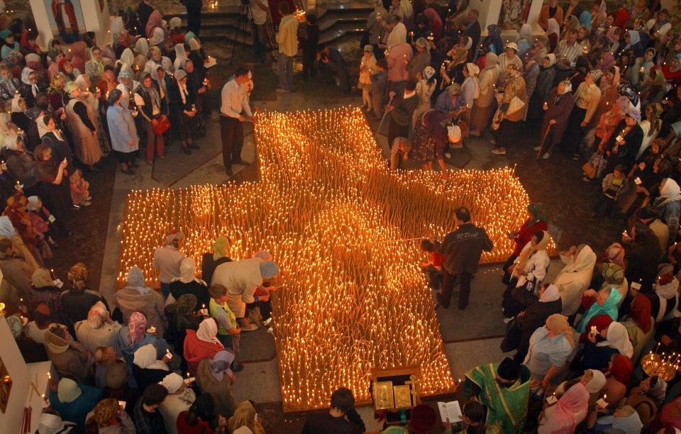 FILE - People light candles during an anti-abortion service in an Orthodox church in Vladivostok, in Russia's Far East, on May 31, 2007. In the span of three decades, Russia went from having some of the world's least-restrictive abortion laws to being what officials call a bulwark of “traditional values,” with the health minister condemning women for prioritizing careers over childbearing. (AP Photo, File)