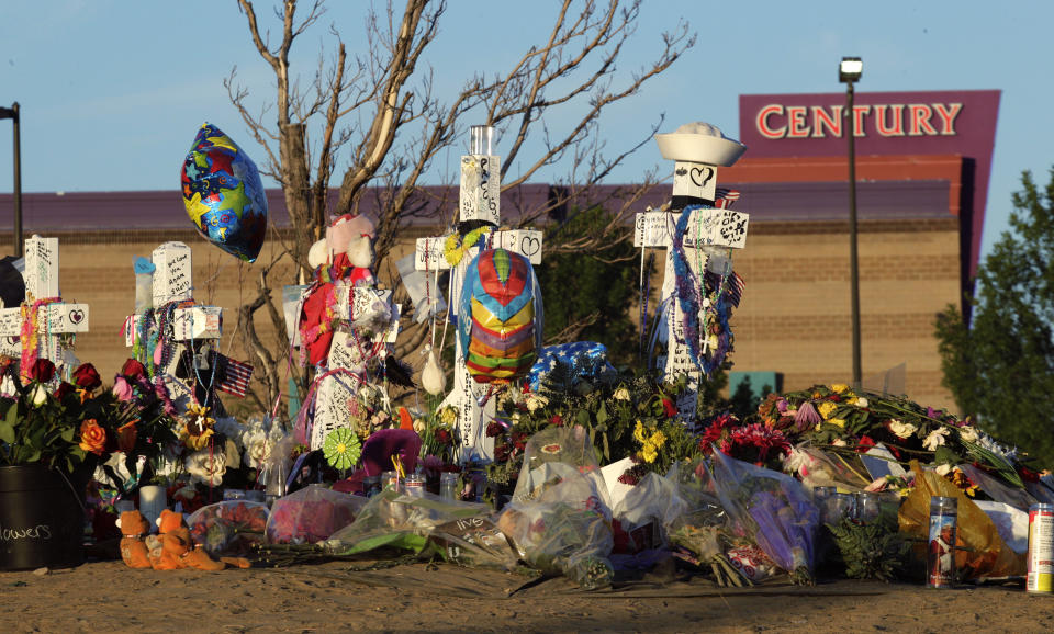 FILE - In this July 27, 2012, file photo, crosses are displayed in honor of the victims of the Aurora, Colo., movie theater shooting, which killed 12 people and injured 70. James Holmes was convicted of murder and attempted murder and sentenced to life in prison without parole for the shootings. In a new book and an interview with The Associated Press, psychiatrist William H. Reid, who spent hours talking with Holmes, says what led Holmes to open fire was a vortex of his mental illness, his personality and his circumstances, along with other, unknown factors. (AP Photo/Ted S. Warren, File)