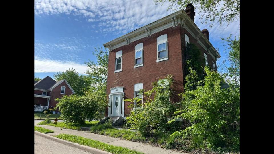 The two-story brick home at 321 W. C St. in Belleville was considered a “mansion” in the late 1800s. Today, it’s vacant, derelict and partly obscured by overgrown trees and bushes.
