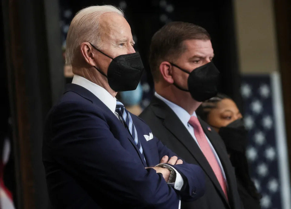 President Biden stands by with Labor Secretary Marty Walsh prior to signing an executive order on federal construction project contracts and labor agreements during a visit to Ironworkers Local 5 in Upper Marlboro, Maryland, February 4, 2022. REUTERS/Leah Millis