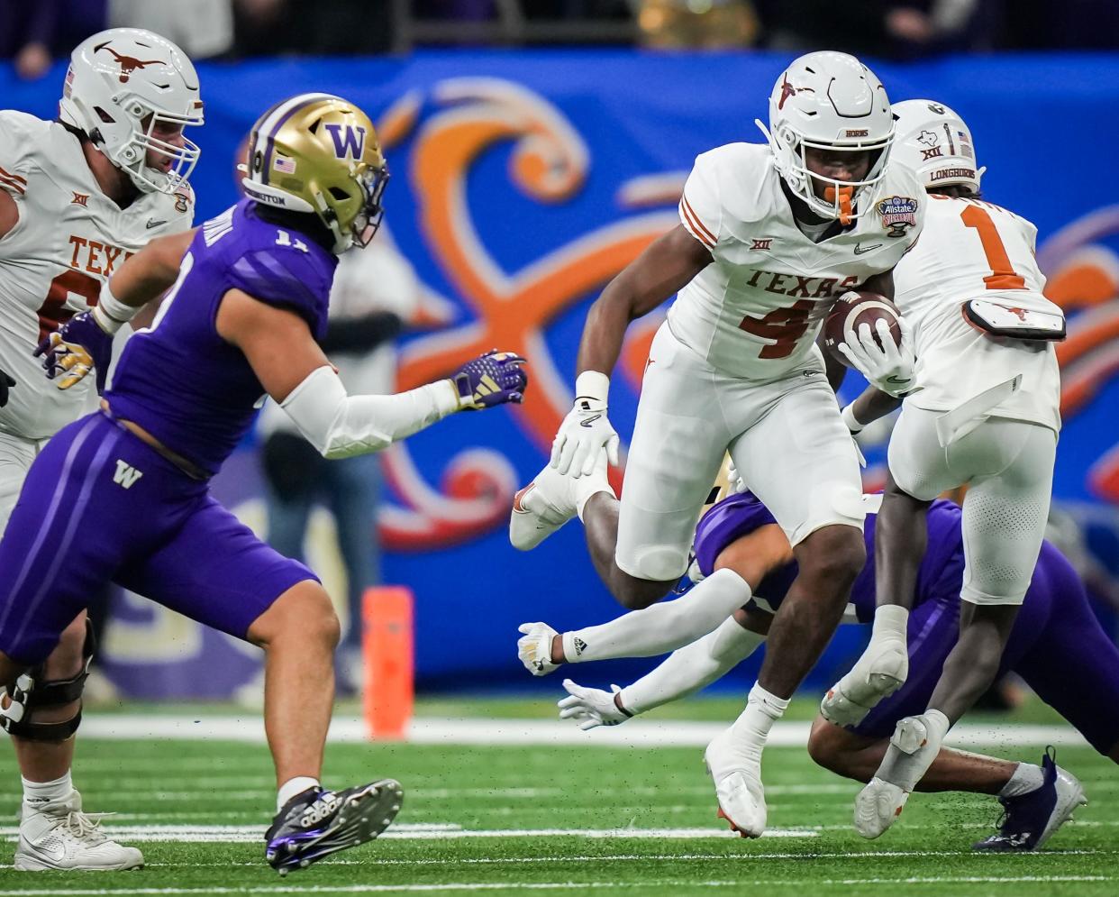 Texas' CJ Baxter evades the Washington defense during the Huskies' win in the CFP semifinals. Baxter returns as part of a deep group of running backs that includes Jaydon Blue and a couple of promising freshmen.