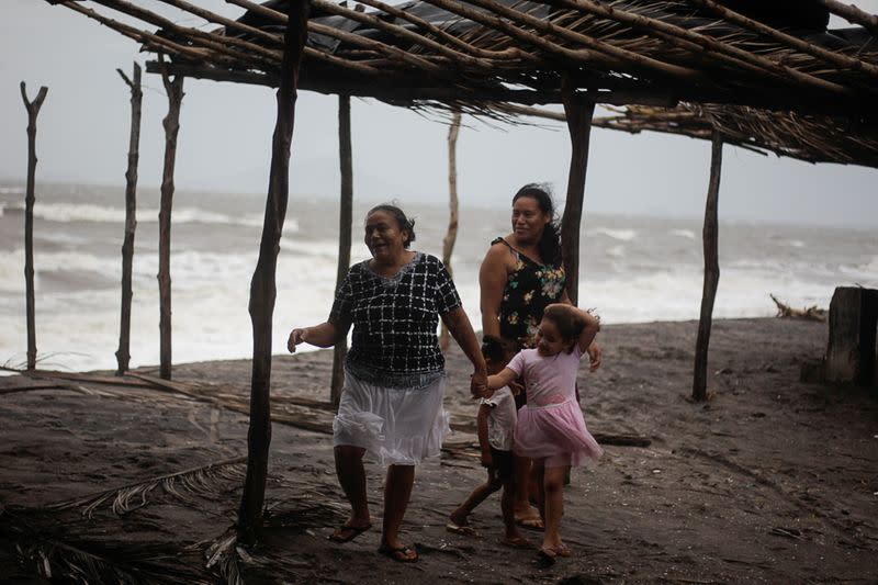 Women react to the wind as Storm Iota approaches, in Cedeno