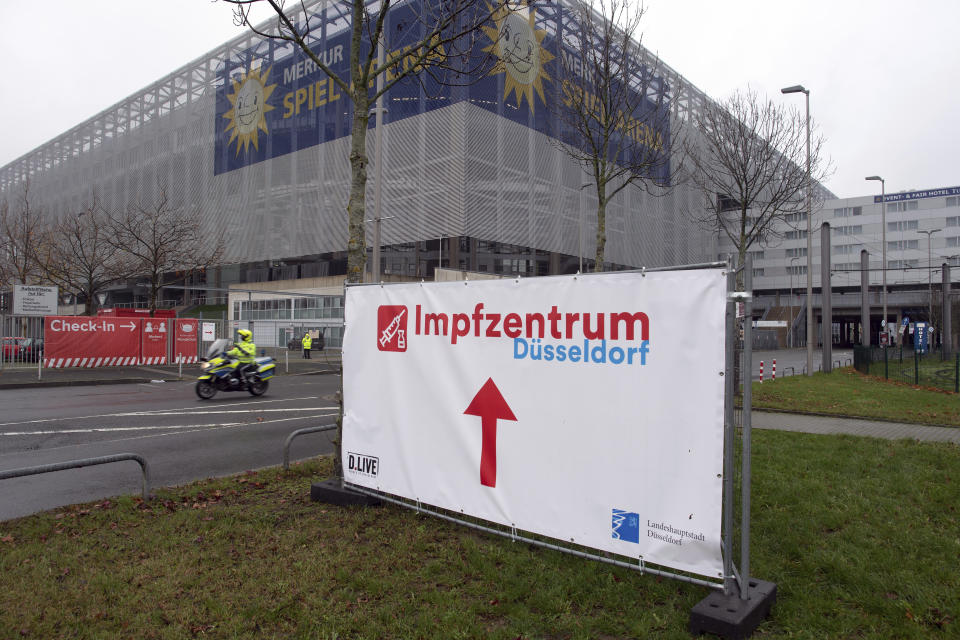 An information sign for a vaccination center stands in front of a soccer stadium, home of German second division team Fortuna Duesseldorf, in Duesseldorf, Germany, Tuesday, Dec. 1, 2020. The German government is preparing to roll out a nationwide coronavirus vaccination program. (Federico Gambarini/dpa via AP)