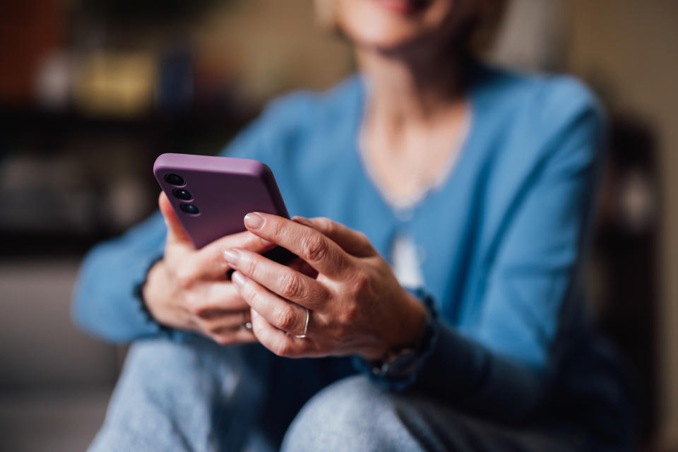 Woman in casual wear using a smartphone