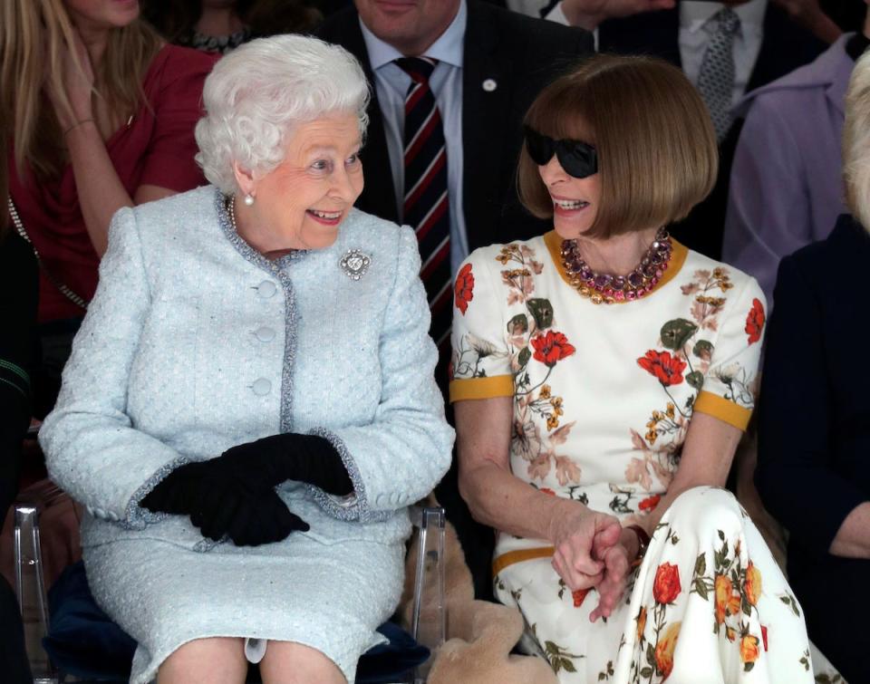 Britain's Queen Elizabeth sits next to fashion editor Anna Wintour as they view Richard Quinn's runway show