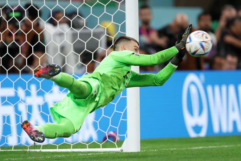 AL RAYYAN, QATAR - DECEMBER 09: Dominik Livakovic of Croatia makes a save against Rodrygo of Brazil in the penalty shootout during the FIFA World Cup Qatar 2022 quarter final match between Croatia and Brazil at Education City Stadium on December 09, 2022 in Al Rayyan, Qatar. (Photo by Alex Grimm/Getty Images)