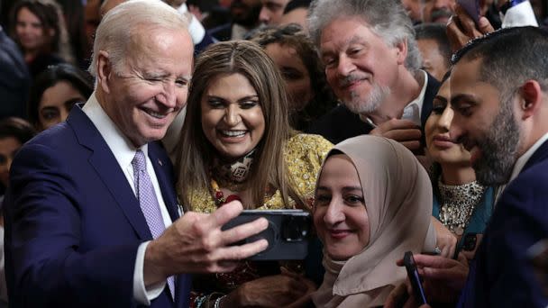 PHOTO: President Joe Bidentakes selfies with guests during a reception celebrating Eid-al-Fitr in the East Room of the White House, May 1, 2023. (Alex Wong/Getty Images)