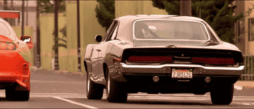 A car pops a wheelie as it pulls off