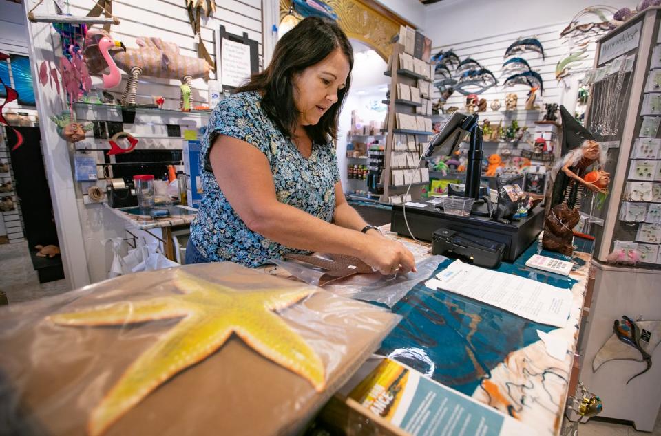 Monique Lee, store manager at Matlacha Menagerie, prepares some merchandise for sale Monday, September 25, 2023. The store is currently fully operational and available to customers. Almost a year after Hurricane Ian impacted the area, some businesses are still in the process of recovery.