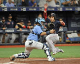 Tampa Bay Rays catcher Michael Perez, left, waits for the throw as Boston Red Sox's Steve Pearce scores on Xander Bogaerts' two-run single during the sixth inning of a baseball game Sunday, April 21, 2019, in St. Petersburg, Fla. (AP Photo/Steve Nesius)