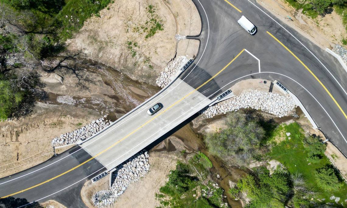 A car crosses the newly completed Dry Creek Bridge in the Fresno County foothills on Friday, April 19, 2024. The $4.8 million project was funded by federal transportation funds and the state gas tax and replaces a century-old wooden bridge.