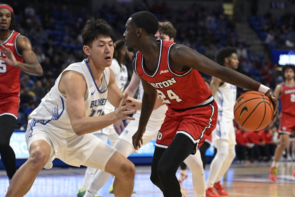 Dayton's Kobe Elvis, right, is defended by Saint Louis' Bruce Zhang during the first half of an NCAA college basketball game Tuesday, March 5, 2024, in St. Louis. (AP Photo/Joe Puetz)