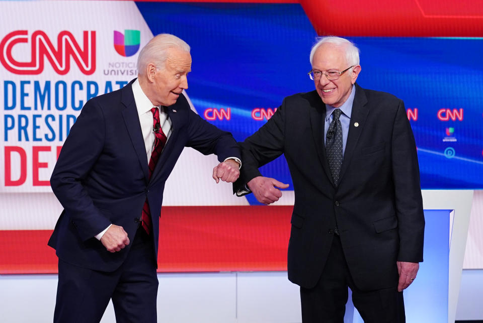 Democratic presidential hopefuls former US vice president Joe Biden (L) and Senator Bernie Sanders (R) greet each other with an elbow bump as they arrive for the 11th Democratic Party 2020 presidential debate in a CNN Washington Bureau studio in Washington, DC on March 15, 2020. (Photo by MANDEL NGAN / AFP) (Photo by MANDEL NGAN/AFP via Getty Images)