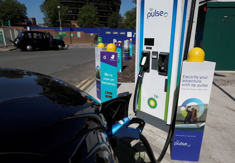 FILE PHOTO: An electric powered taxi is seen being charged at a BP Pulse electric vehicle charging point in London