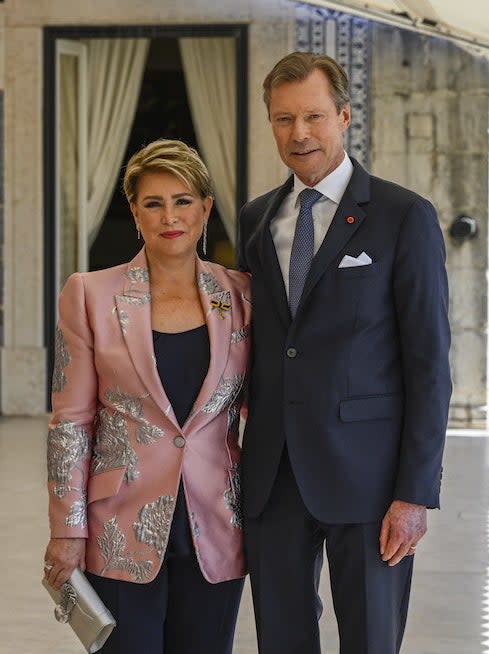 the grand duke and duchess smiling and standing with their arms around each other