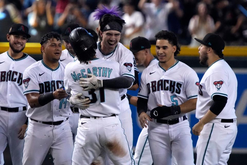 Arizona Diamondbacks' Corbin Carroll, center right, celebrates with Ketel Marte (4), Jake McCarthy (31), Lourdes Gurriel Jr. (12), and Alek Thomas (5) after hitting a walkoff RBI single against the Pittsburgh Pirates in the 10th inning during a baseball game, Saturday, July 8, 2023, in Phoenix. (AP Photo/Rick Scuteri)