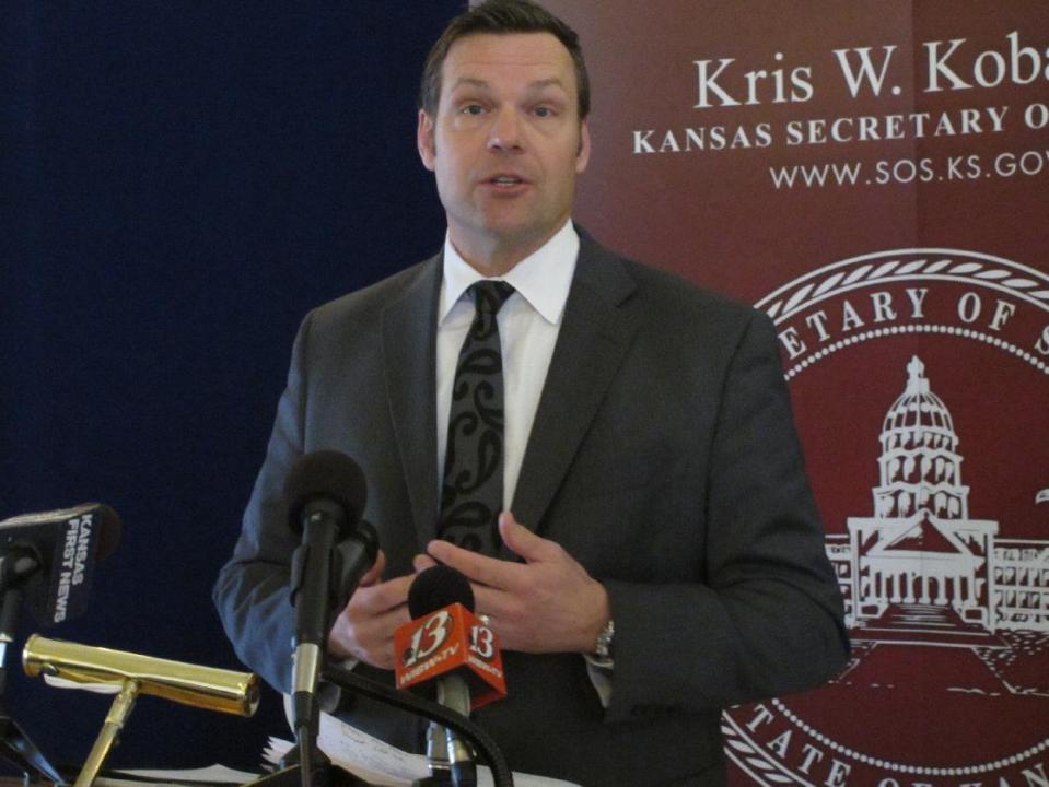 Kansas Secretary of State Kris Kobach discusses a federal judge's ruling ordering the federal government to help Kansas and Arizona enforce their proof-of-citizenship requirements for new voters, Wednesday, March 19, 2014, in Topeka, Kan. Kobach and Arizona Secretary of State Ken Bennett filed a lawsuit over the issue. (AP Photo/John Hanna)