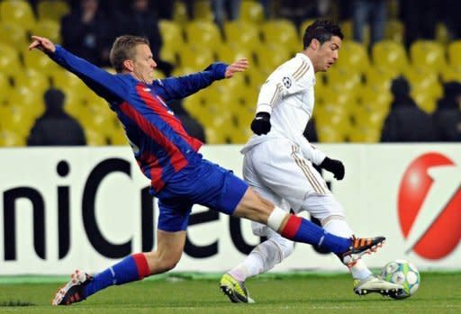 Cristiano Ronaldo (R) of Real Madrid fights for the ball against Pontus Wernbloom (L) of CSKA Moscow during their round of 16, first leg match UEFA Champions League in Moscow. The match ended in a 1-1 draw