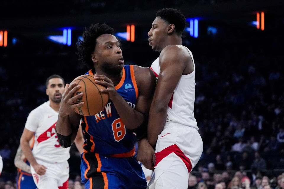 Toronto Raptors guard RJ Barrett draws an offensive foul against New York Knicks forward OG Anunoby (8) during the first half of an NBA basketball game in New York, Saturday, Jan. 20, 2024. (AP Photo/Peter K. Afriyie)