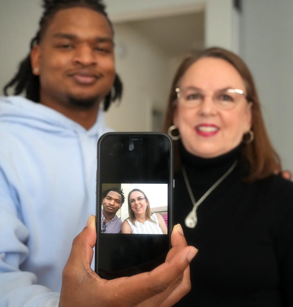 After an errant text in 2016 initially connected the two strangers on Thanksgiving, Jamal Hinton and Wanda Dench have shared the holiday over the last seven years, forming a friendship that has become their own tradition. The pair are seen here at Dench's Mesa home on Wednesday, Nov. 23, 2022, holding a photo from their first meeting.